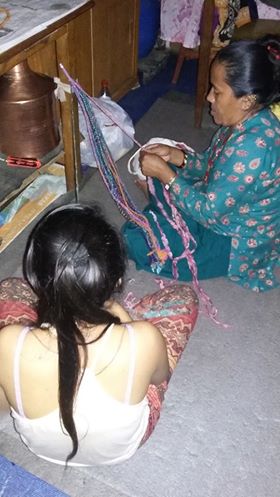 Kesh Maya and her daughter Muna is making necklaces of vintage saris