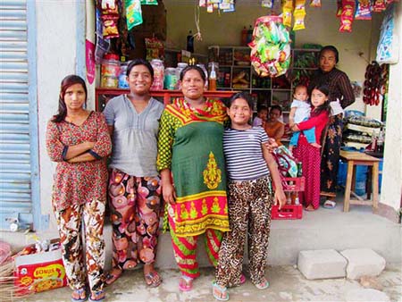 Maya, her daugthers and a sister outside her shop